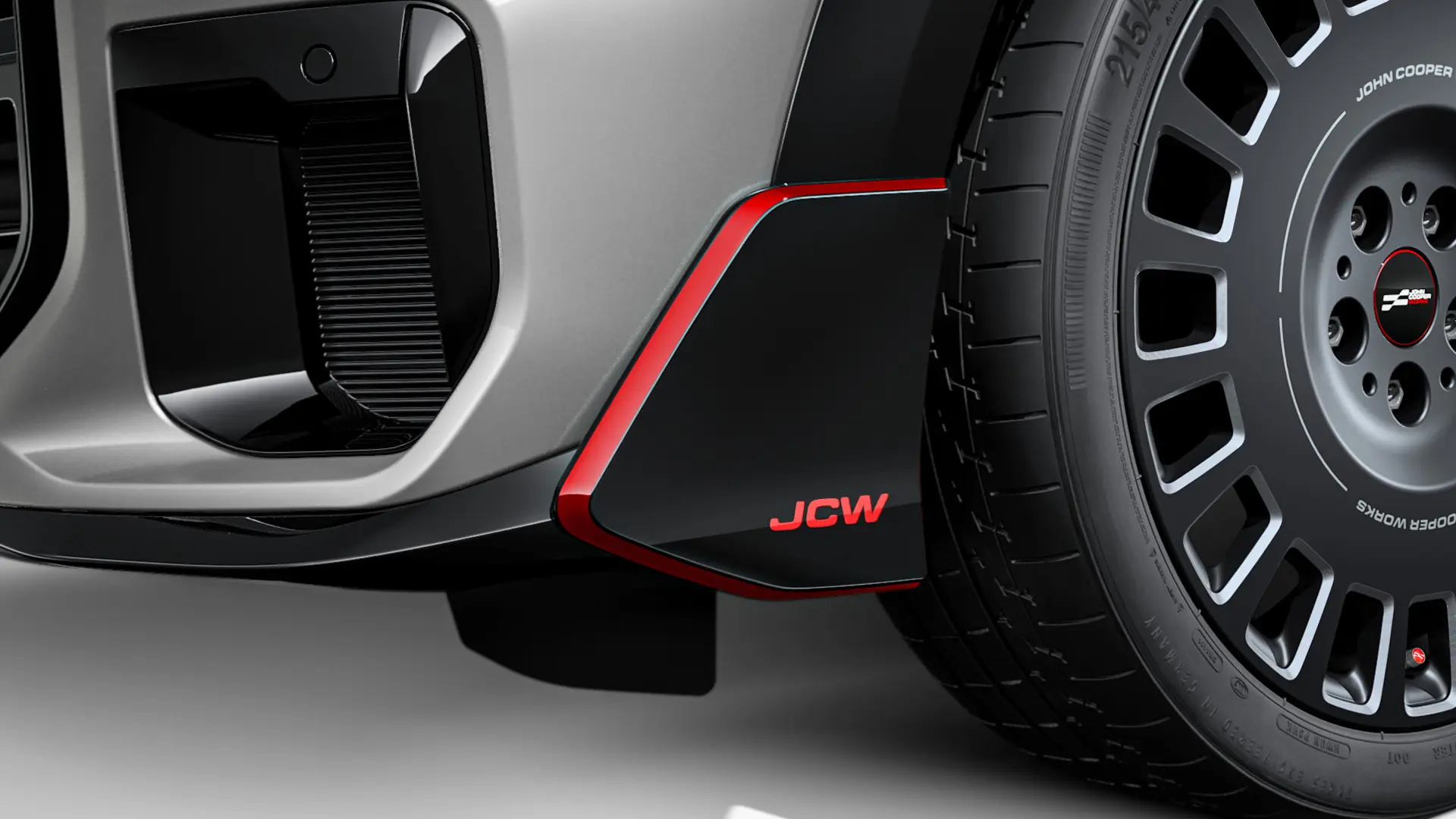 MINI John Cooper Works winglets foran i sort højglans med røde JCW-bogstaver og accentstriber.